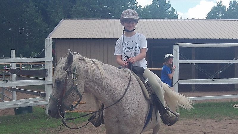 Kid riding a horse Summer Camp