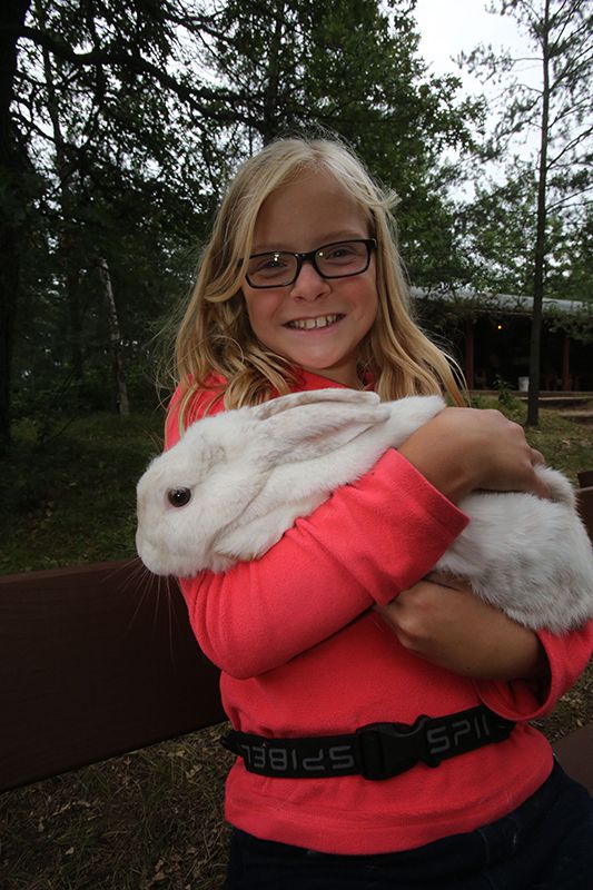 Kid with a rabbit in an overnight camp summer camp