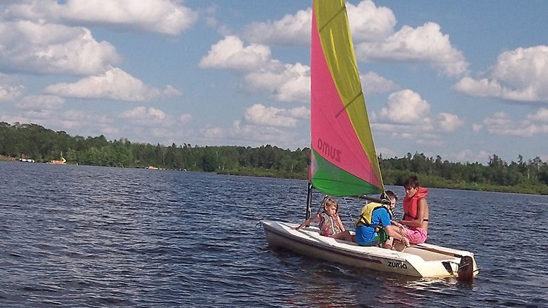 Summer Camp kids in sailboat